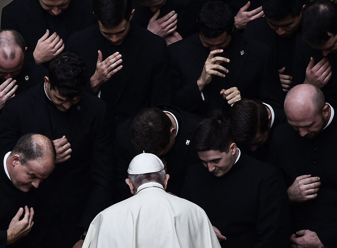 Pope Francis prays with priests at the end of a limited public audience at the San Damaso courtyard in The Vatican on Sept. 30, 2020.