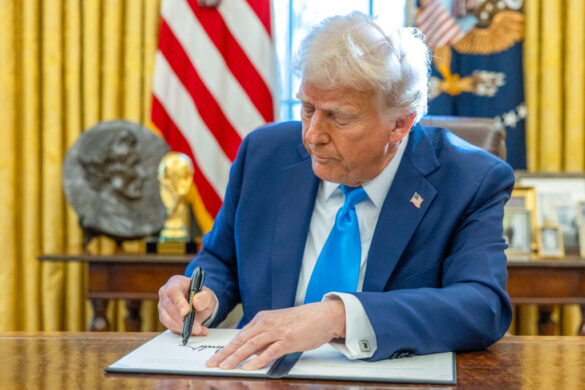 US President Donald Trump signs an executive order in the Oval Office of the White House in Washington, DC, US, on Feb. 4, 2025.  