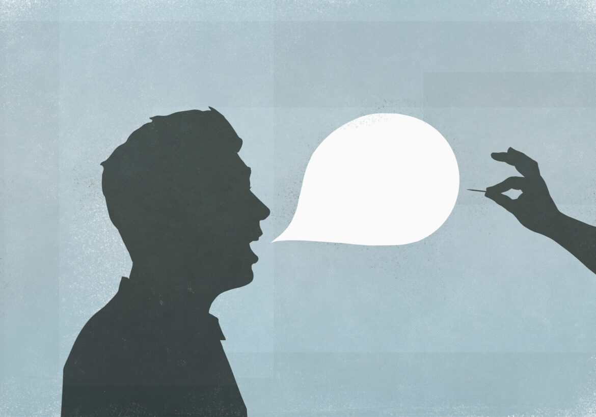 Hand with pin popping speech bubble